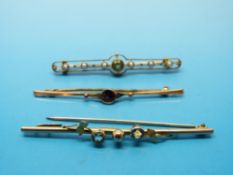 Three Edwardian bar brooches, two marked 9ct, one set with peridots and seed pearls,