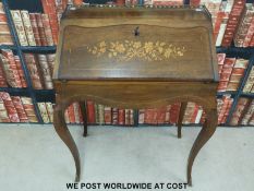 A continental ladies bureau, the fall flap opening to reveal three drawers and secret compartment,