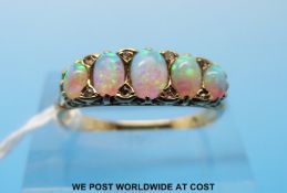 An Edwardian 18ct gold ring set with five oval opals and diamonds (size P)