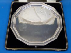 A cased hallmarked silver dodecagon-shaped salver raised on four stepped feet, Sheffield 1924,