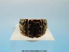 A yellow metal ring marked 18ct gold with dragon and Chinese character decoration, (size S, 7.
