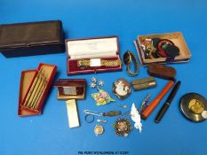 A collection  of brooches including a Victorian silver example, badges and jewellery-making tools,