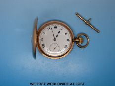 A Swiss made keyless 9ct gold half hunter pocket watch with an enamel face and Roman numerals