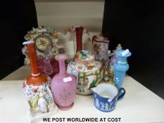 A collection of ceramics and glass including a figural clock, cranberry glass,