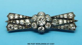 A Georgian/ Victorian brooch set with old mine cut diamonds in a central flower cluster,