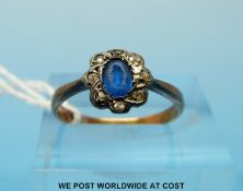 A Victorian ring set with a blue stone surrounded by old cut diamonds (size L/M)