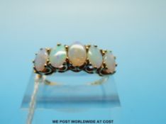 A 9ct gold ring set with five oval opals (size N)