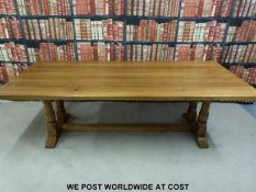 A Wilf 'Squirrelman' Hutchinson adzed oak table and ten upholstered chairs with drop in seats.