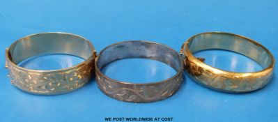 One silver bangle and two rolled gold bangles
