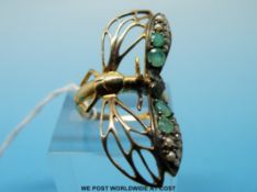 A silver gilt ring set with emeralds,