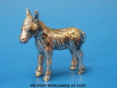 A white metal model of a donkey (length 5.