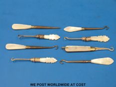 Eight various button hooks with mother-of-pearl handles including a hallmarked silver folding