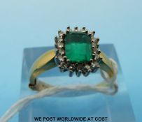 An 18ct gold ring set with an emerald cut emerald of approximately 0.