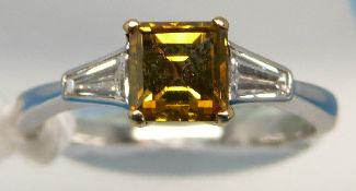 A platinum ring set with a laboratory grown square cut yellow diamond of approximately 0.
