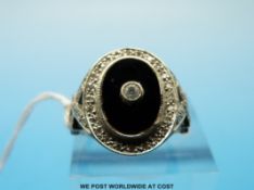 A 9ct white gold ring set with onyx and diamonds (size N)