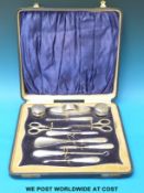 A cased and engine turned hallmarked silver 11 piece manicure / dressing table set,