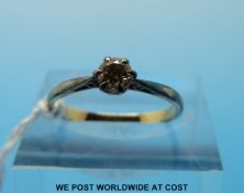 A yellow metal ring set with a round brilliant cut diamond (size L)