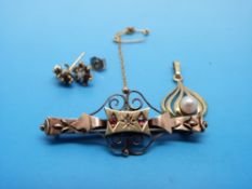 A 9ct gold brooch set with a diamond and rubies,