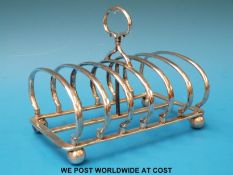 A heavy Victorian hallmarked silver six-division toast rack raised on ball feet, Ldn 1890,