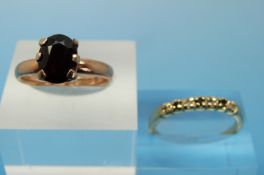 A 9ct gold ring set with a garnet (size O) and another ring