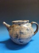 An earthenware teapot, cream slip with cobalt blue brushwork and incised signature,