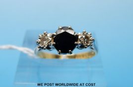 An 18ct gold ring set with a sapphire flanked by two diamonds (size M)