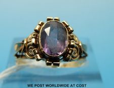 An 18ct gold ring set with a purple sapphire (size N)