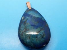 An unusual large blue pendant in a pear shape with yellow metal fitting
