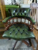 A green leather button-back captain's chair