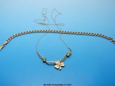 A 9ct gold necklace with clover pendant set with diamond and peridots and a 9ct gold bracelet