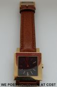Bulgari 18ct gold gentleman's wristwatch with black face and date aperture   on brown leather strap.