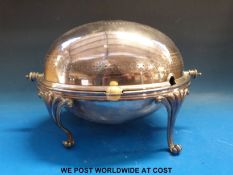 A silver plated serving dish with swivel top