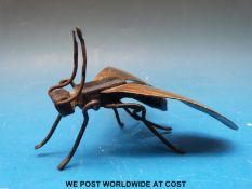 A metal fly with brass wings (length 9.