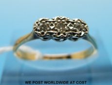 An 18ct gold ring set with three diamonds in a platinum setting (size N/O)