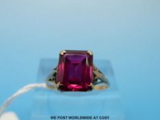 A 9ct gold ring set with a red stone (size O)