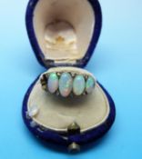 An Edwardian gold ring set with five oval opals and diamonds,