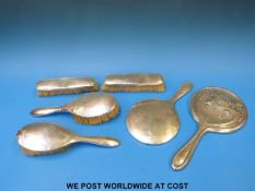 A hallmarked silver dressing table set comprising mirror and four brushes together with a further