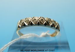 A 9ct gold ring set with seven diamonds (size N)