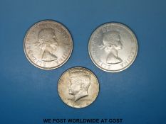 Two Canadian silver dollars for 1960 and 1961 together with a Kennedy half dollar for 1964