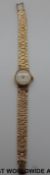 Longines 9ct gold ladies wristwatch on 9ct gold bark effect strap.
