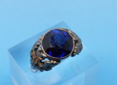A white metal ring set with a large round cut sapphire (size M)