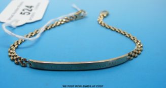 A yellow metal identity bracelet marked 9ct (4.