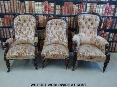 Three matching Victorian mahogany spoon-back salon chairs raised on ceramic castors