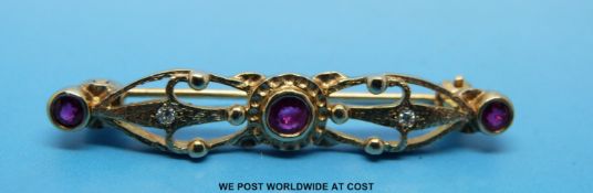 A 9ct gold brooch set with three rubies