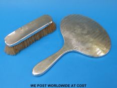 A hallmarked silver dressing table mirror and a hallmarked silver brush