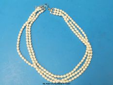 A three strand pearl necklace