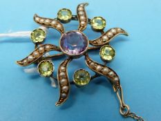 An Edwardian brooch set with an amethyst to the centre surrounded by peridot and seed pearls 3.