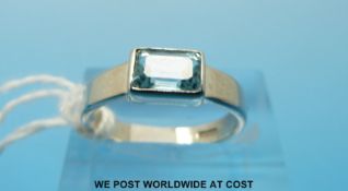 A 9ct white gold ring set with an emerald cut aquamarine (size M)