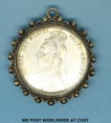 An 1889 Victorian shilling in white metal mount (VF)