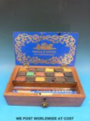A late 19th century or early 20th century Winsor & Newton watercolour paint box,
